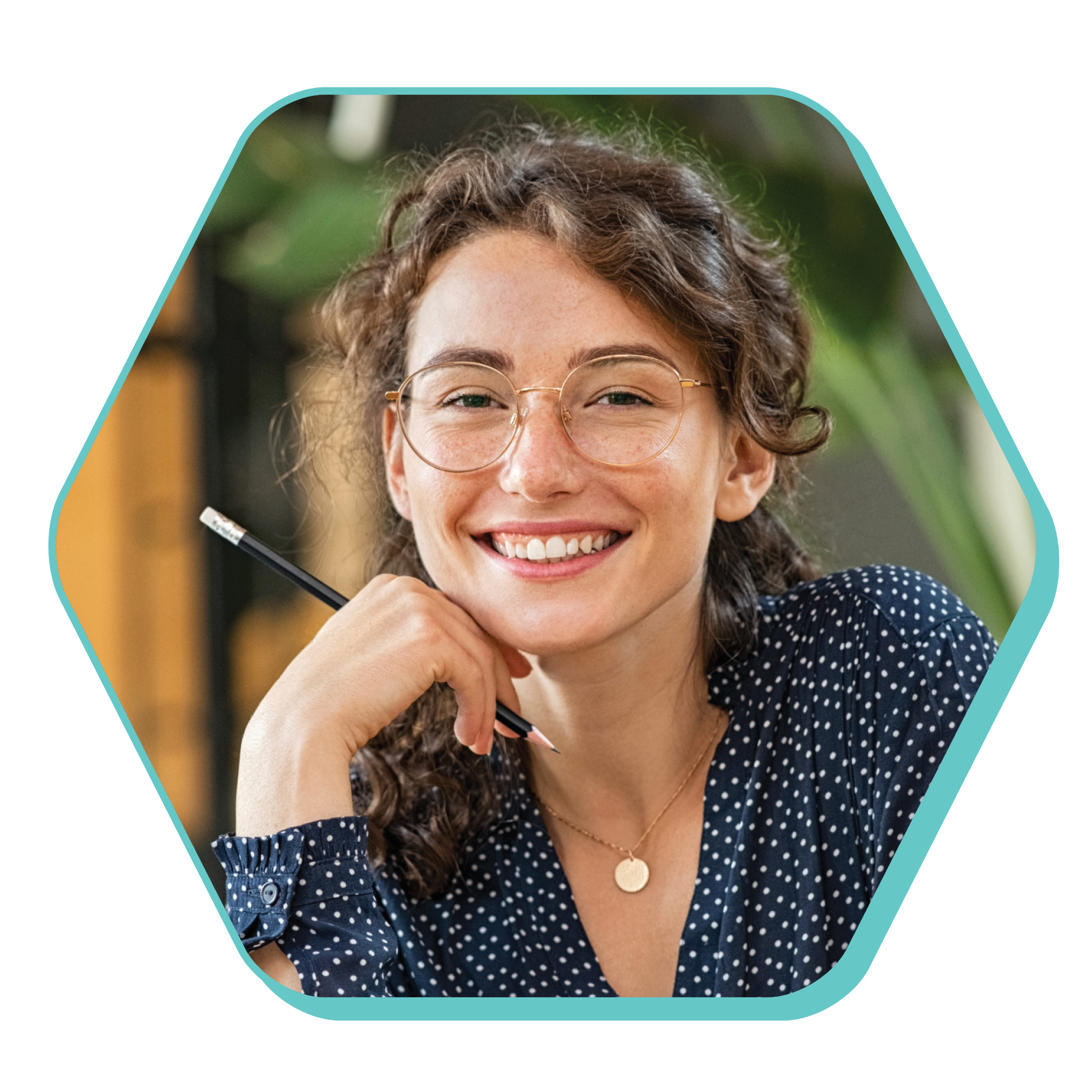 Smiling caucasian young woman with curly brown hair and blue blouse holding a pencil